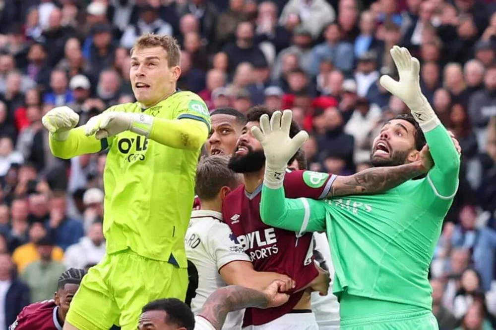 Arsenal and West Ham players grapple at a corner during Sunday's Premier League match