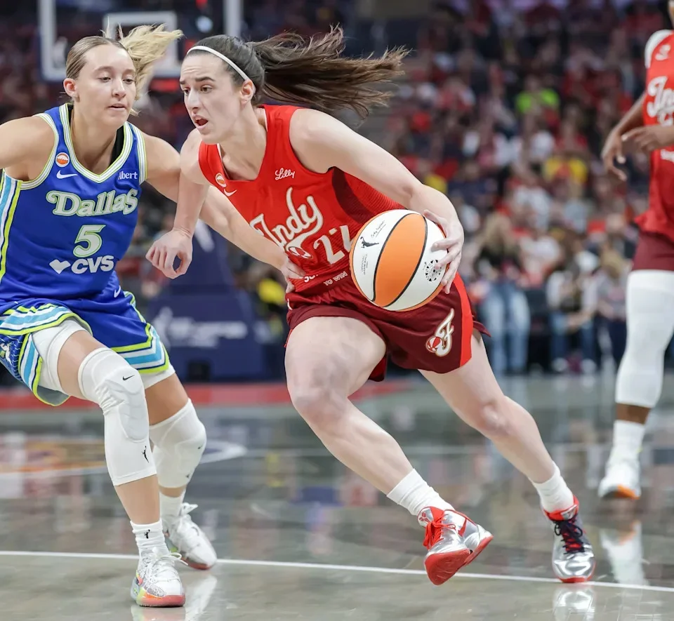 Caitlin Clark of the Indiana Fever dribbles the ball against Paige Bueckers of the Dallas Wings.